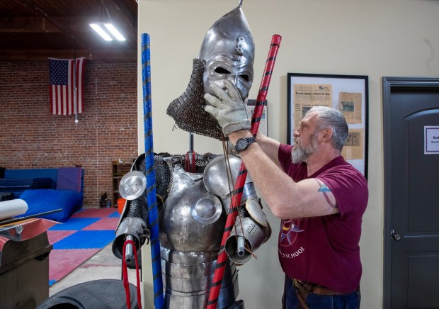 Steaphen Fick, founder of the Davenriche European Martial Arts School, returns head gear to his harness, March 23, 2023, in San Jose, Calif. (Karl Mondon/Bay Area News Group)