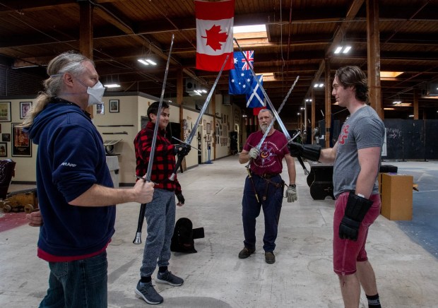 Steaphen Fick, second from right, and his Davenriche European Martial Arts School students Niall Doherty, left, Kevin Ryan, and Connor Nef, salute each other at the end of class, Thursday, March 23, 2023, in San Jose, Calif. (Karl Mondon/Bay Area News Group)