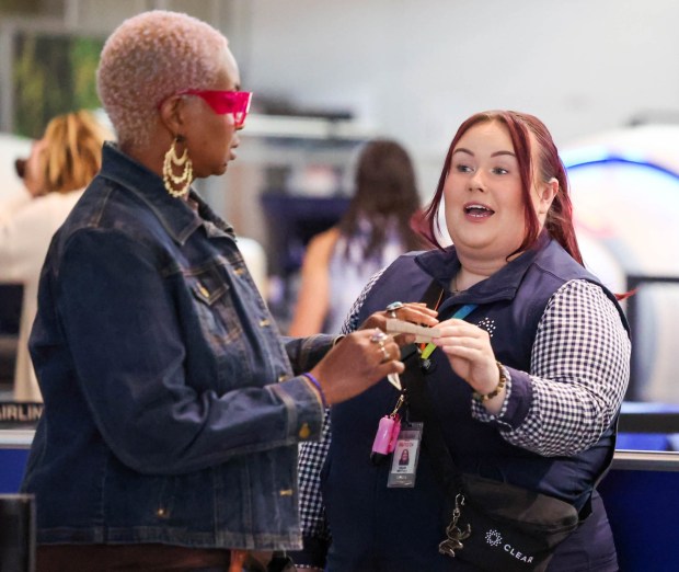 A traveler is escorted by a Clear Plus ambassador for faster check-in at the TSA security line at the Oakland International Airport in Oakland, Calif., on Wednesday, May 1, 2024. (Ray Chavez/Bay Area News Group)