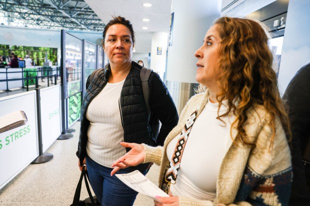 Travelers Angie Reposo, left, of Walnut Creek, and Karla Ibarra, of Vallejo, are on their way to the security checkpoint at the Oakland International Airport in Oakland, Calif., on Wednesday, May 1, 2024. (Ray Chavez/Bay Area News Group)