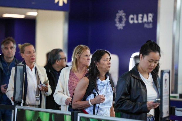 Travelers wait in line to check-in at the security checkpoint next to a Clear Plus line at the Oakland International Airport in Oakland, Calif., on Wednesday, May 1, 2024. (Ray Chavez/Bay Area News Group)