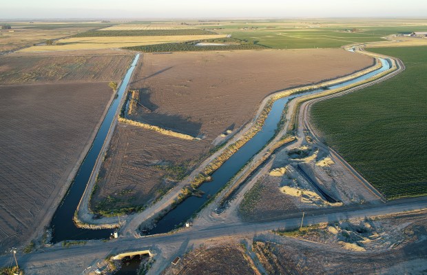 KINGS COUNTY, CALIFORNIA - JULY 7: Construction is halted on a 48-inch water pipe which had planned to go under the Tulare Lake Canal, right, in Kings County just south of Stratford, Calif., on Thursday, July 7, 2022. The land is owned by Sandridge Partners, which is controlled by John Vidovich. The canal is controlled by the Tulare Lake Canal Company, which is owned by the J.G. Boswell Company. (Nhat V. Meyer/Bay Area News Group)