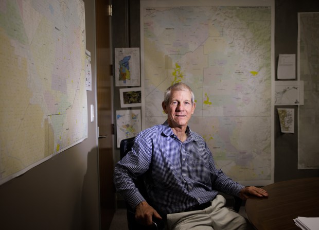 John Vidovich, a prominent South Bay land developer, poses for a portrait with maps of his Central Valley acreage on July 8, 2022, in his Los Altos office. (Dai Sugano/Bay Area News Group)