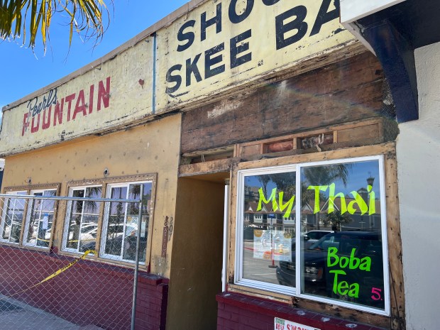 Business signage dating back roughly three generations was discovered in near-perfect condition beneath layers of plaster above My Thai Beach in Capitola Village. (PK Hattis - Santa Cruz Sentinel)